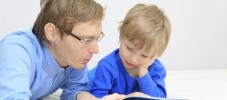 Father and son reading together