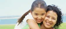 portrait of a daughter riding piggyback on her mother