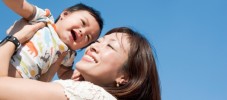 Asian family - baby and mother with blue sky